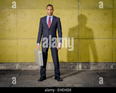 Geschäftsmann Porträt trägt Anzug und Krawatte mit Halliburton Zero Aluminium Aluminium-Aktenkoffer / Attache Case Stockfoto