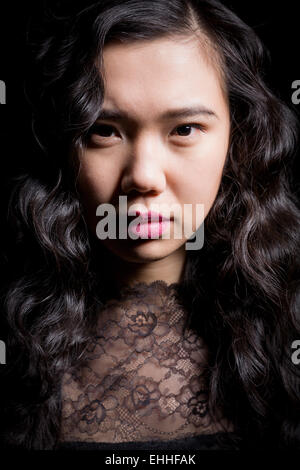Portrait von schöne Mode Modell mit langen Haaren über schwarzen Hintergrund posiert. Stockfoto