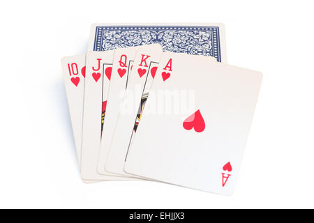 Spielkarten (gerade/Royal Flush von Herzen) oben auf Deck von Karten, isoliert auf weißem Hintergrund Stockfoto