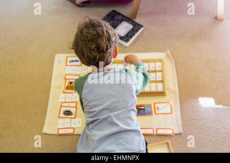 Kaukasische junge Vermittlung von Karten im Klassenzimmer Stockfoto