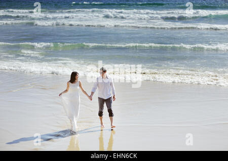 Braut und Bräutigam gemeinsam gehen Hand in Hand in der Nähe von Meer Stockfoto