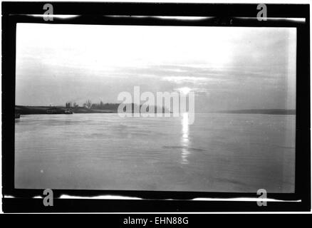 Dieses Bild fängt einen friedlichen Sonnenuntergang über dem Mississippi ein und hebt die wunderschönen Farben des Himmels hervor, während sie auf dem Wasser reflektieren und eine ruhige Landschaft schaffen. Stockfoto
