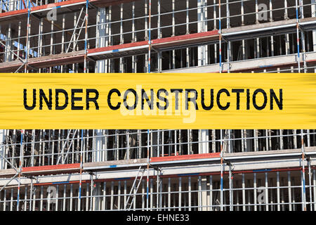 im Bau-Schrift, Hintergrund-Gerüst Stockfoto