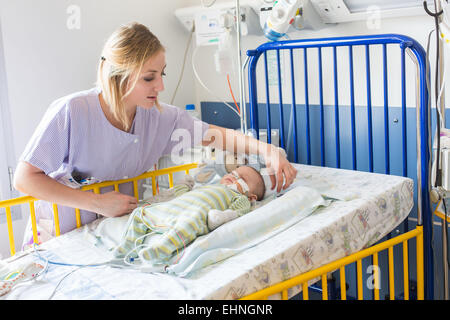 Baby von einer Bronchiolitis betroffen, im Krankenhaus in der pädiatrischen Abteilung des Krankenhauses von Angoulême, Frankreich, hier Rohr füttern. Stockfoto
