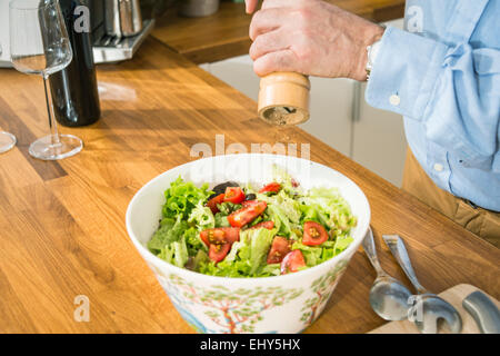 Person Gewürz Salat Stockfoto