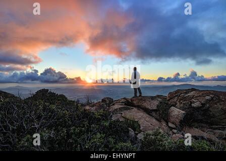 Reifer Mann steht auf einem Berg bei Sonnenuntergang, Cleveland National Forest, USA Stockfoto