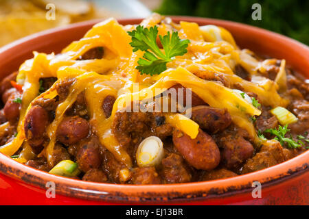 Rindfleisch und Bohnen mexikanischen Chili mit Nacho-Chips und Cheddar-Käse Stockfoto