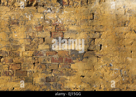 Alte Mauer mit rissigen Putz. Hintergrundtextur. Stockfoto