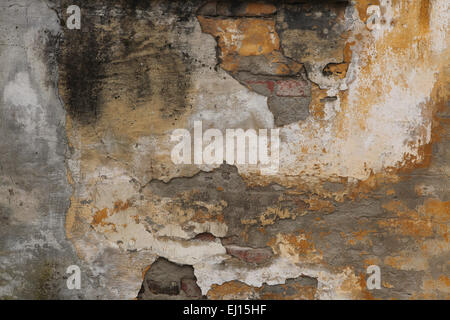 Alte Mauer mit rissigen Putz. Hintergrundtextur. Stockfoto