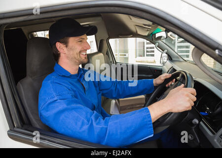 Auslieferungsfahrer lächelnd in seinem van Stockfoto