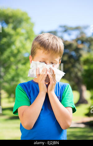 Kleiner Junge bläst seine Nase Stockfoto