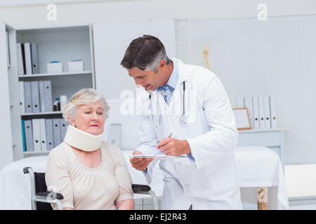 Arzt schreiben Rezept Patienten tragen Neck Brace Stockfoto