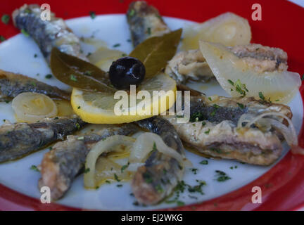 Gebratene marinierte mediterrane Sardinen mit Zwiebeln, Zitrone, Oliven in Olivenöl. Stockfoto