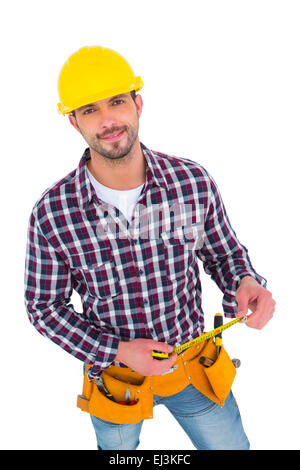 Lächelnd Handyman Holding Maßband Stockfoto
