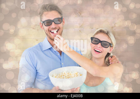 Zusammengesetztes Bild von glücklichen jungen Paar 3d Brille Essen popcorn Stockfoto