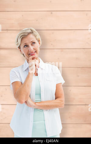 Zusammengesetztes Bild glücklich Reife blonde denken mit Hand am Kinn Stockfoto