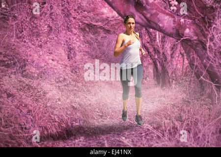 Zusammengesetztes Bild des fokussierten Fit blonde Joggen Stockfoto