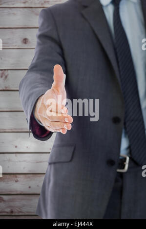 Zusammengesetztes Bild des Kaufmanns, die Hand auszustrecken Stockfoto