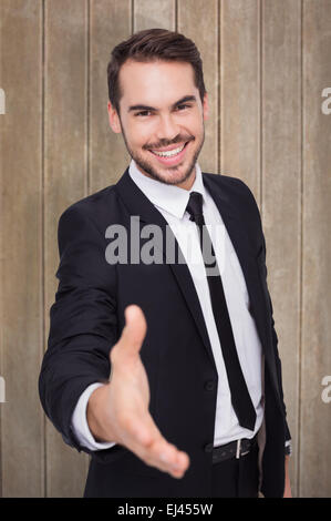 Zusammengesetztes Bild des Porträts von lächelnden Geschäftsmann bietet handshake Stockfoto
