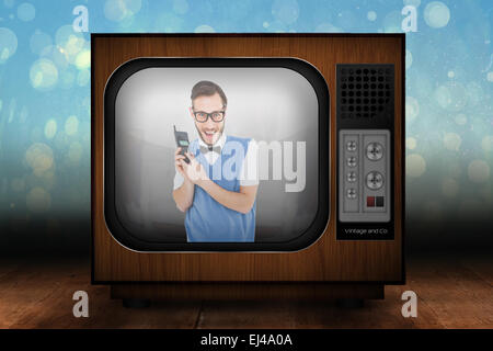 Zusammengesetztes Bild geeky Hipster hält ein Retro-Handy Stockfoto