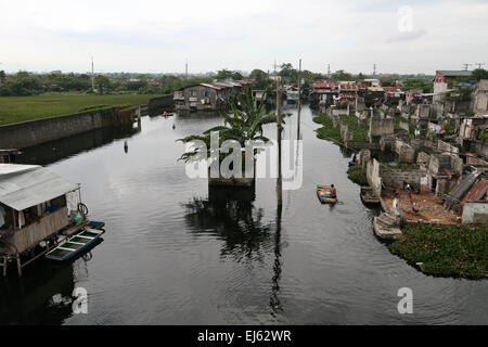 Manila, Philippinen. 22. März 2015. Ein junger Mann Paddel seinen Weg durch die überfluteten Gemeinschaft. Rund 175 Familien leben in Artex Compound in Malabon. Das Wohngebiet ist seit Mitte der 80er Jahre mit Taille Hochwasser überflutet. © J Gerard Seguia/Pacific Press/Alamy Live-Nachrichten Stockfoto