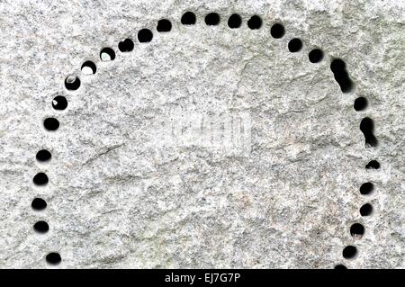 viele Löcher in Granitstein Stockfoto