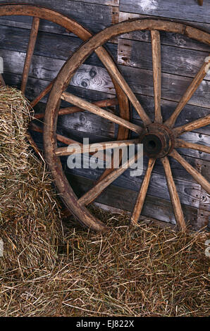 Alte hölzerne Rad auf eine Heu Stockfoto