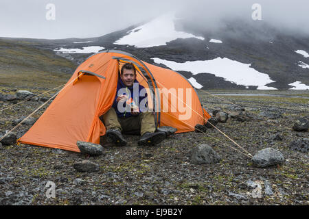 Mann sitzt im Zelt, Abisko Alpen, Lappland Stockfoto