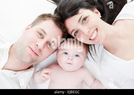 Glückliche Familie, Vater, Mutter und Kind lag auf dem Boden, Stockfoto