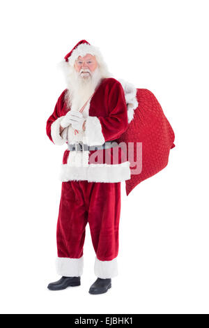 Santa trägt seine rote Tasche Stockfoto