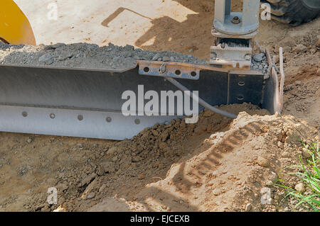 Bau-Planierschild von ein grader Stockfoto