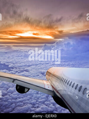 Erste kommerzielle Fluggesellschaft Jet Flugzeug fliegen über Wolken bei Sonnenaufgang Stockfoto