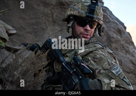 US Army Staff Sgt Lucas A. Kammerer, Führer einer Einheit zugeordnet Bushmaster Unternehmen, 1. Bataillon, 327th Infanterie-Regiment, erklimmt einen Hügel hinunter nach der Suche einer Höhle für Waffen während der Operation Bulldog Biss im Pech River Valley, Provinz Kunar, Afghanistan, am 25. November 2010.   Staff Sgt Mark Burrell, US-Armee. Stockfoto