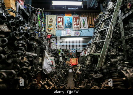 25. Februar 2015 - Bangkok, Thailand - Blick aus dem Inneren einen Shop, wo wir, beide sehen können, Seite einen Berg von Gebrauchtwagen-Motor und einer kleinen Gasse in der Mitte führt zu das Haus der Arbeiter. Chengkon ist ein Bereich innerhalb Talad Noi in der Chinatown Bezirk von Bangkok, wo rauh aussehende Männer verbringen den ganzen Tag, in den Schlamm arbeiten fast ohne Schutz Hände. Dies ist eines der lukrativen Unternehmen in Thailand, die meisten Autos sind japanische Marke aus Japan importieren, wenn sie zu alt, oder in Thailand gestohlen wurden, sie zerlegen, Reparatur, Neueinbau und Re über Thailand zu verkaufen, oder exportieren in Entwicklungsdienst Stockfoto