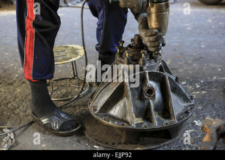 Bangkok, Bangkok, Thailand. 25. Februar 2015. Ein Mann reparieren ein Bestandteil eines Automotors in seinem Geschäft. Chengkon ist ein Bereich innerhalb Talad Noi in der Chinatown Bezirk von Bangkok, wo rauh aussehende Männer verbringen den ganzen Tag, in den Schlamm arbeiten fast ohne Schutz Hände. Dies ist eines der lukrativen Unternehmen in Thailand, die meisten Autos sind japanische Marke aus Japan importieren, wenn sie zu alt, oder in Thailand gestohlen wurden, sie zerlegen, Reparatur, Neueinbau und Re über Thailand zu verkaufen, oder exportieren Sie in Ländern wie Pakistan, Bangladesh, Afrika. © Guillaume Payen/ZUMA Draht/Alamy Live-Nachrichten Stockfoto