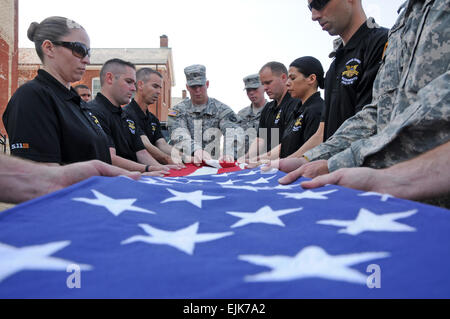 Sgt. Brent Austin, Sarg Teamleiter, Honor Guard Company, 3d US Infanterie Regiment der alten Garde, Mitglieder von der Ehrengarde Sacramento Polizei-Abteilung lehrt, wie man eine Flagge am Joint Base Myer-Henderson Hall, VA., Apr. 9 Falten. Die alte Garde primäre Aufgabe ist es, gefallenen Servicemembers im Nationalfriedhof Arlington, VA. alte Garde Soldaten ruhen zu legen bis zu 10 Beerdigungen an einem Tag durchführen kann.  US Armee Sgt. Luisito Brooks Stockfoto