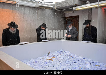 4 religiöse jüdische Mann beten im Schnee bei einem Besuch in das Grab des Lubawitscher Rebbe in Cambria Heights, Queens, New York City. Stockfoto