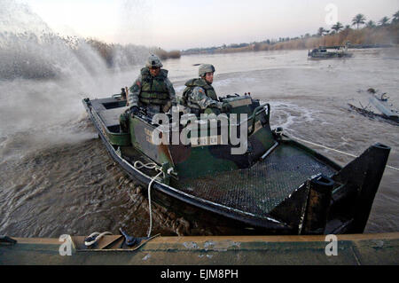 US-Armeesoldaten verwenden ein Boot um einen Abschnitt des Schwebens Assault Float Brücke entfernt, bevor sie eine neue ein February11 versammeln sich 2007 im Camp Taji, Irak zu ziehen. Stockfoto