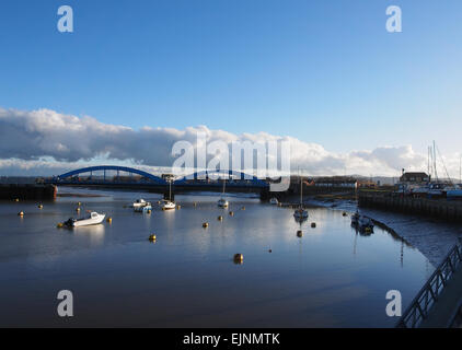 Boote vertäut am Yachthafen in Kimnel Bay, Rhyl in Wales mit der blauen Brücke im Hintergrund. Stockfoto