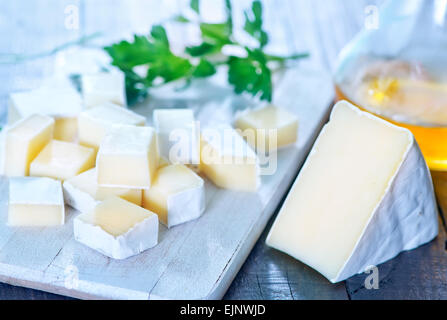Camembert Käse an Bord und auf einem Tisch Stockfoto