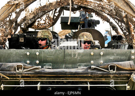 US Army Lieutenant Colonel Henry I. B. McNeilly, links, und US Army Lieutenant Colonel Thomas M. Feltey bieten hinten Sicherheit in einem gepanzerten Fahrzeug Stryker als Bestandteil ein Konvoi mit der neue Kommandeur der regionalen Befehl Septmber in der afghanischen Provinz Kandahar, 11. Juli 2013. McNeilly befiehlt der 2nd Infantry Division 1. Bataillon, 6. Feldartillerie-Regiment und Feltey befiehlt der 1st Infantry Division 2. Bataillon, 23. Infanterie-Regiment.  Staff Sgt Shane Hamann Stockfoto