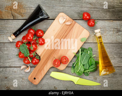 Cherry-Tomaten mit Salat und Gewürze über Holztisch Hintergrund Stockfoto