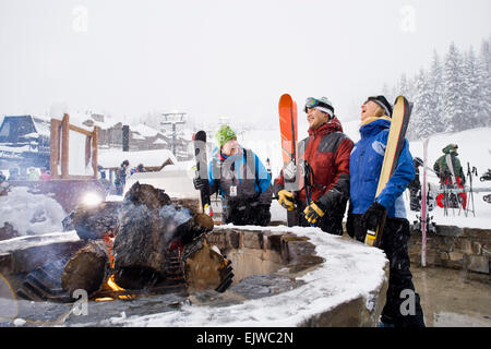 USA, Montana, Felchen, Gruppe von Freunden mit Lagerfeuer im winter Stockfoto