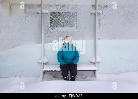 Massachusetts, Boston, USA, Mitte im Alter Frau im Bus-Stop, Winterschnee Stockfoto