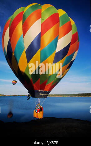 Eine bunte Ballons übernimmt in den Himmel einen lokalen See am Farmington Ballonfest in Farmington, New Mexico Stockfoto