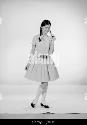 Modell Jennifer Goddard. Braunhaarige Mädchen im karierten Kleid mit Pig tails Stockfoto