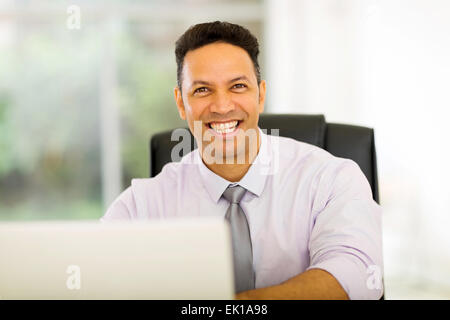 Porträt der schönen mittleren Alter Geschäftsmann vor laptop Stockfoto