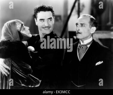 Alma Rubens, John Gilbert, Frank Reicher, am Set of the Silent Film "Die Masken des Teufels", 1928 Stockfoto