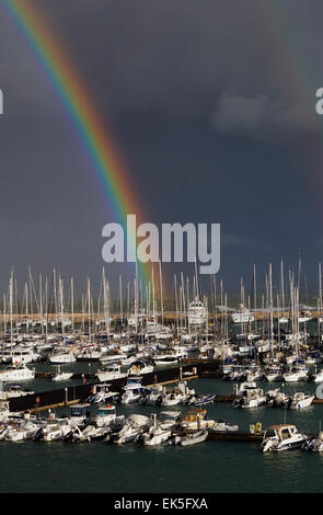 Italien, Sizilien, Mittelmeer, Marina di Ragusa - 27. März 2014: Ansicht von Luxus Yachten in der Marina mit einem Regenbogen in der cl Stockfoto