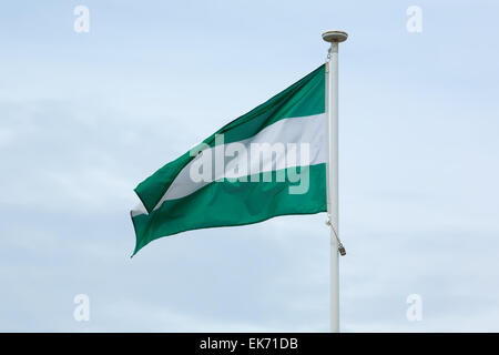 Flagge der autonomen Gemeinschaft Andalusien über den Himmel Stockfoto